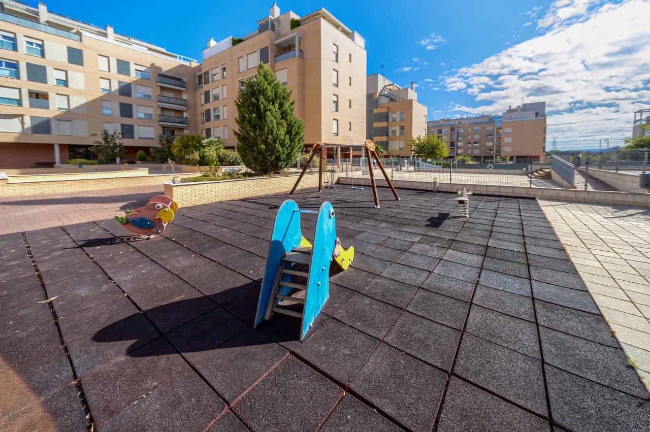 Juegos infantiles de la urbanización vistos desde el paseo